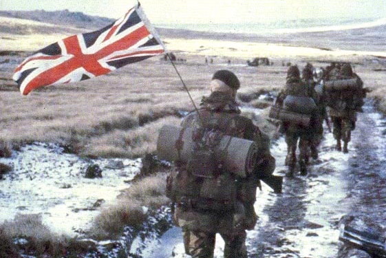 British soldiers walk through the Falkland Islands during the Falklands War.