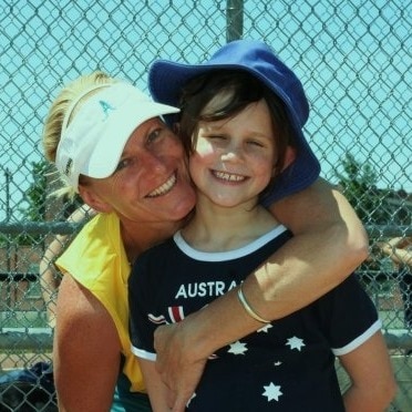 Tanya Harding holds her young daughter Renee at a softball field.