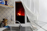 Lava is seen through the window of a kitchen following the eruption of a volcano in El Paso.