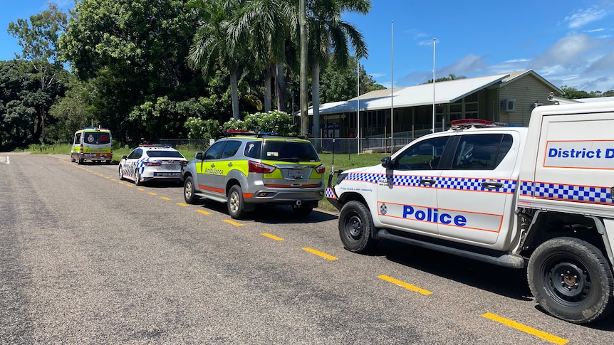 Emergency service vehicles parked outside a school