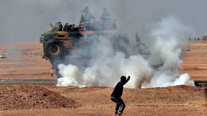 Kurdish man throws stones