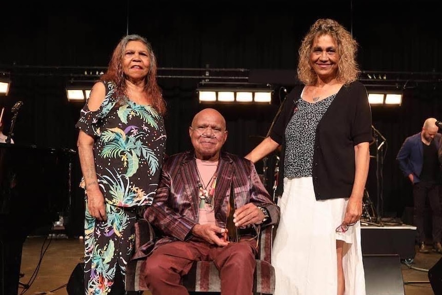 Dianne Roach, Archie Roach, and Tracy Roach standing next to each other and smiling.
