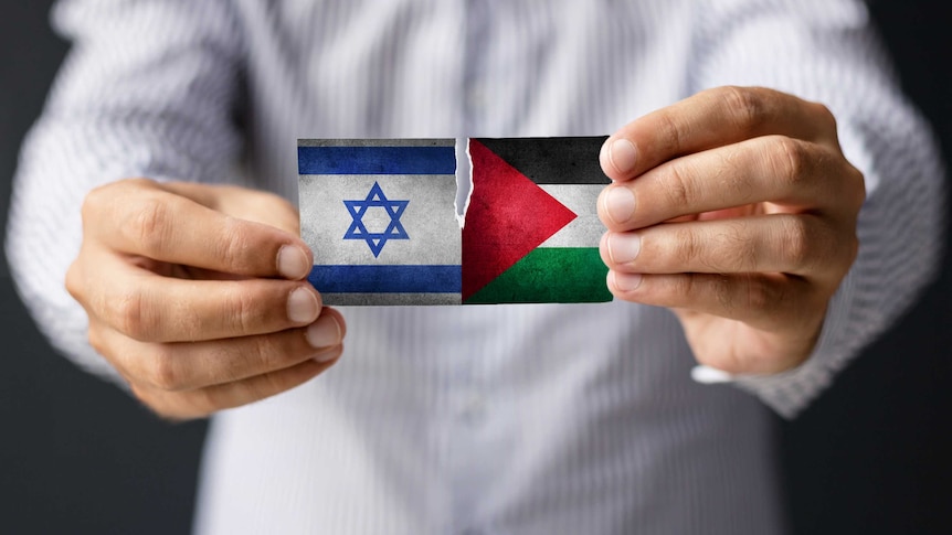 Close-up of man holding Israeli and Palestine flag.