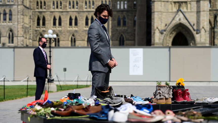 MrTrudeau visits a memorial covered in children's shoes in recognition of remains found at Kamloops school.  