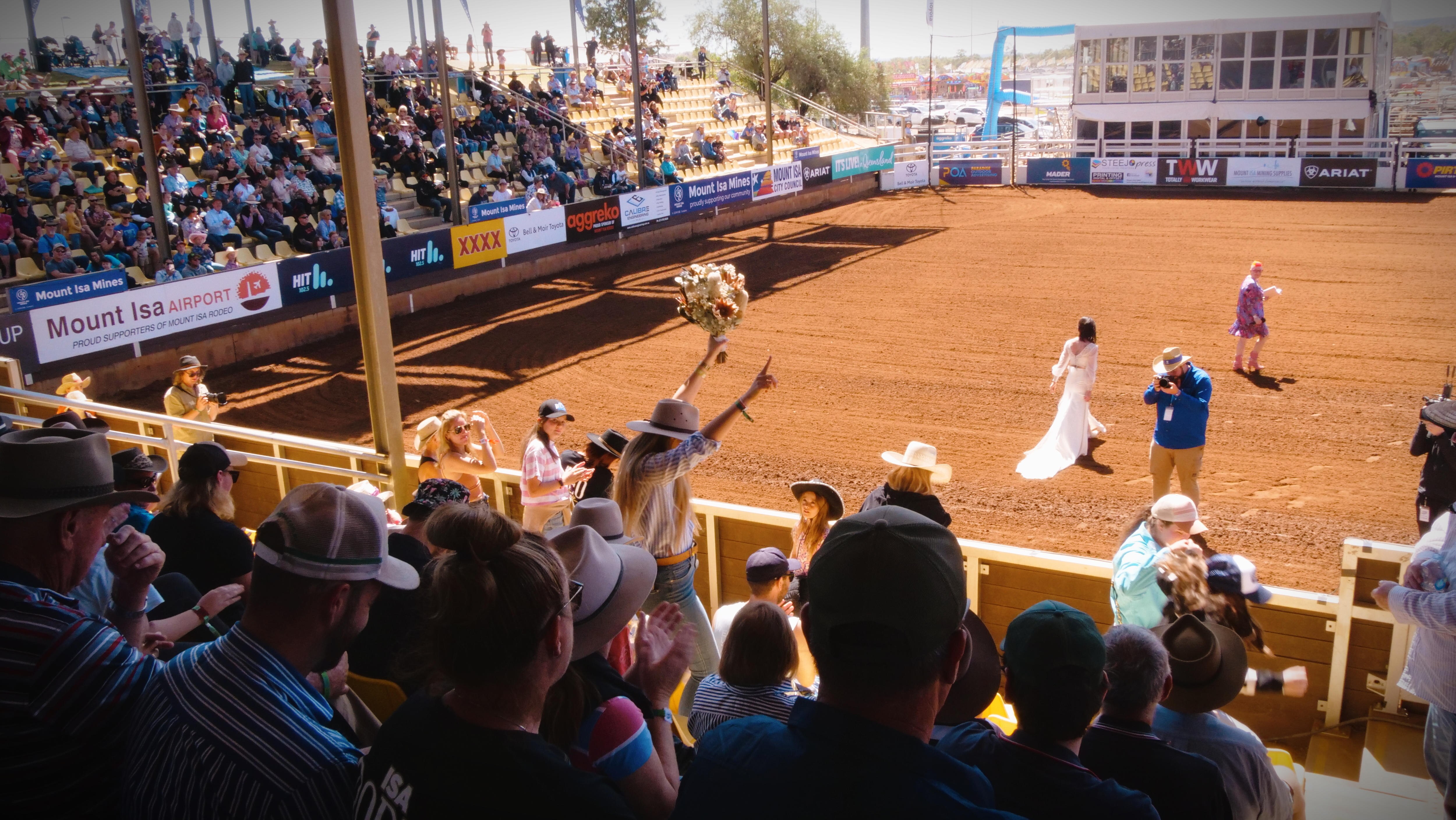 A shot of the bouquet toss taken from the crowd.