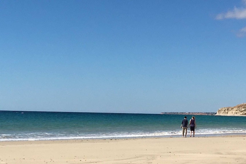 Sarah and her son Ethan share a beach walk