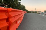 An orange barricade is erected on a suburban street at Coolangatta.