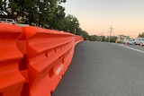 An orange barricade is erected on a suburban street at Coolangatta.