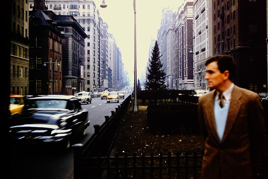 John Gorman in the foreground out of focus with a new york avenue in the background in focus