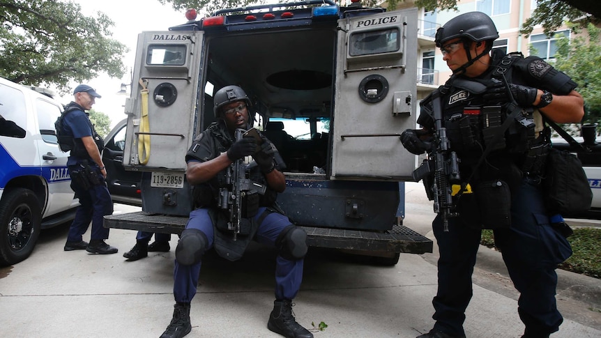 Dallas police SWAT team members stand in front of the city's police headquarters.