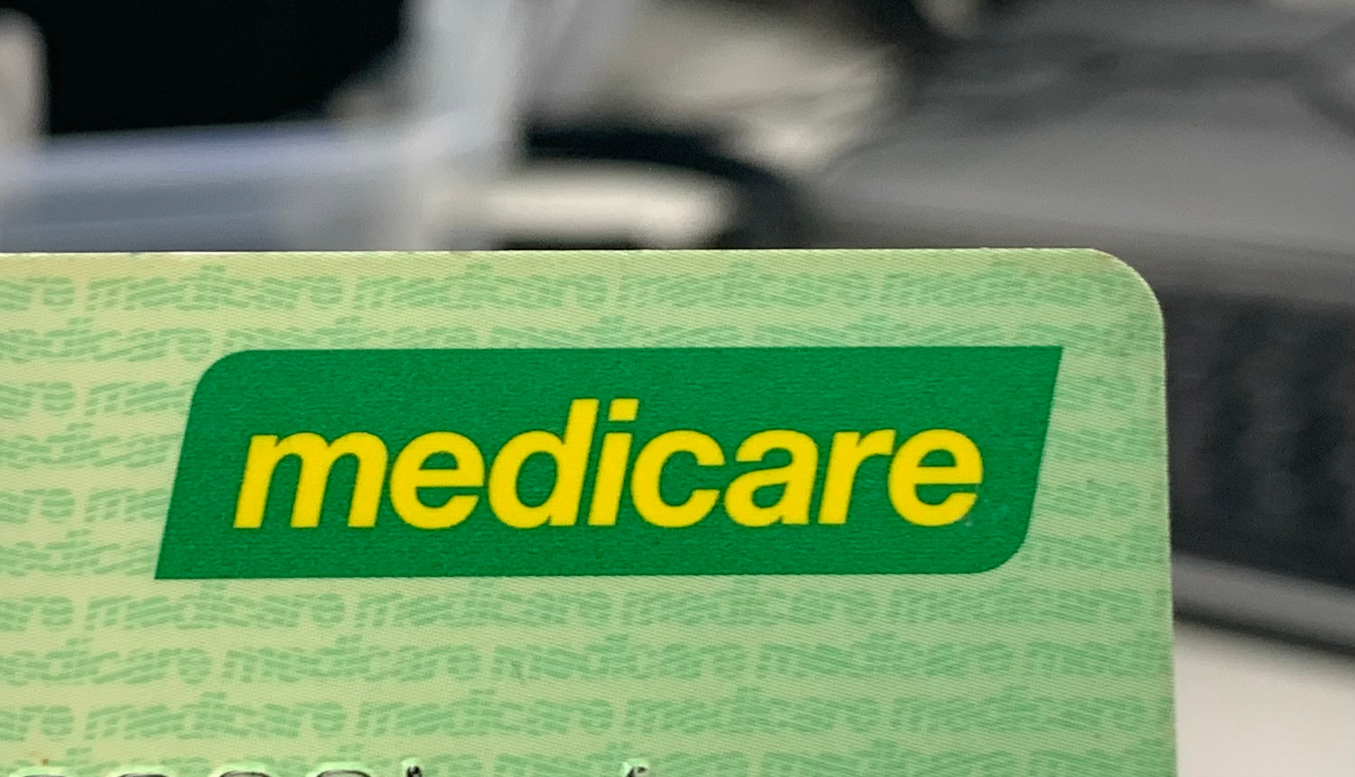 The corner of a green card with the Medicare logo 