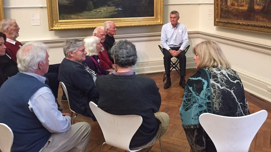 A group of people sitting down at the Art Gallery of New South Wales