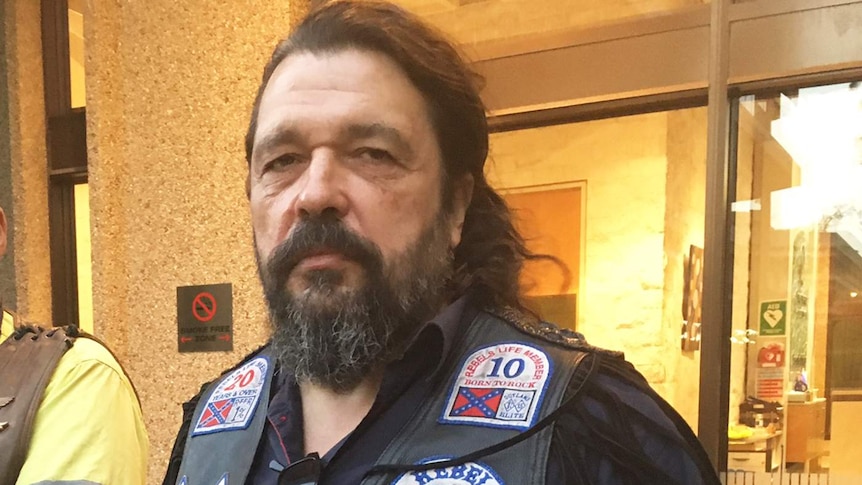 Mick Kosenko from the United Motorcycle Council wearing bikie colours on his leather vest.