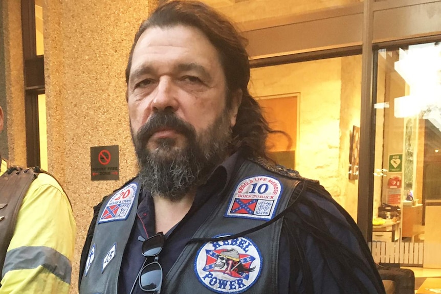 Mick Kosenko from the United Motorcycle Council wearing bikie colours on his leather vest.