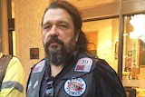 Mick Kosenko from the United Motorcycle Council wearing bikie colours on his leather vest.