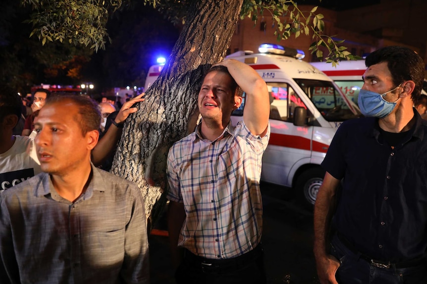 A man whose relative is on staff at Sina Athar Clinic weeps after its explosion, outside the clinic in Tehran.