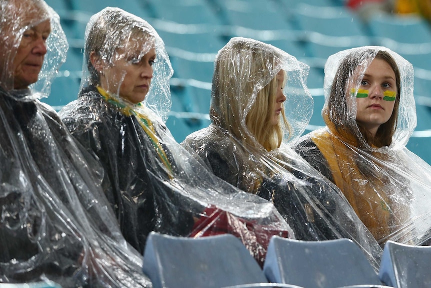 Show of support ... Socceroos fans wait in the rain