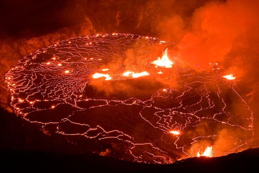 Lava is seen in a dark crater 