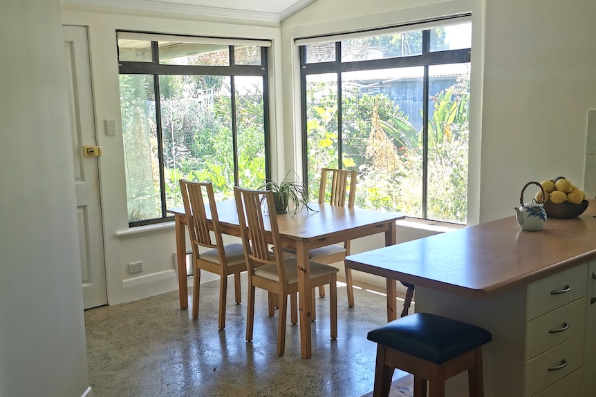 A table and chairs sit in an open-plan kitchen dining room.