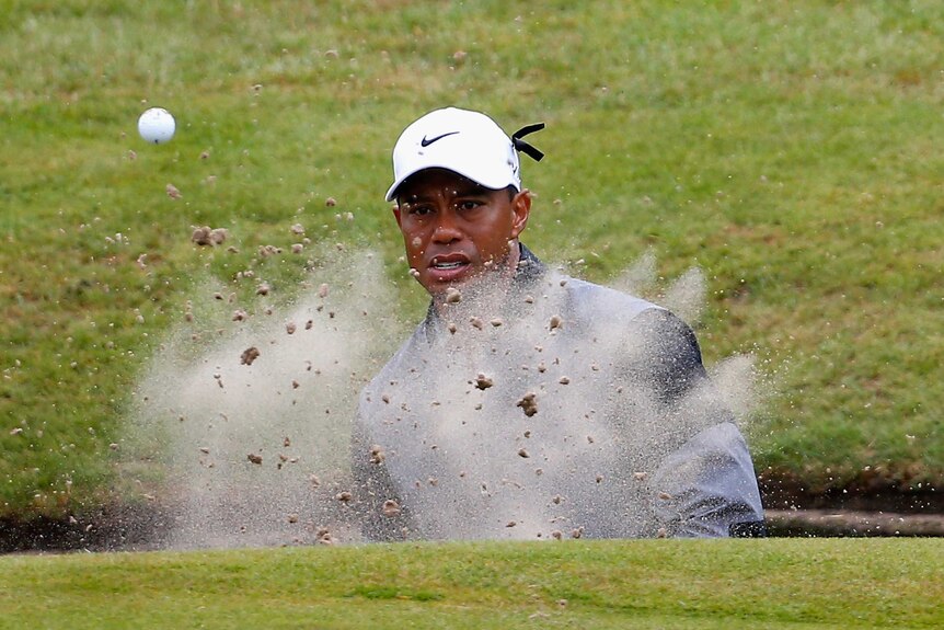 Tiger Woods hits out of the bunker during his third round at the British Open.