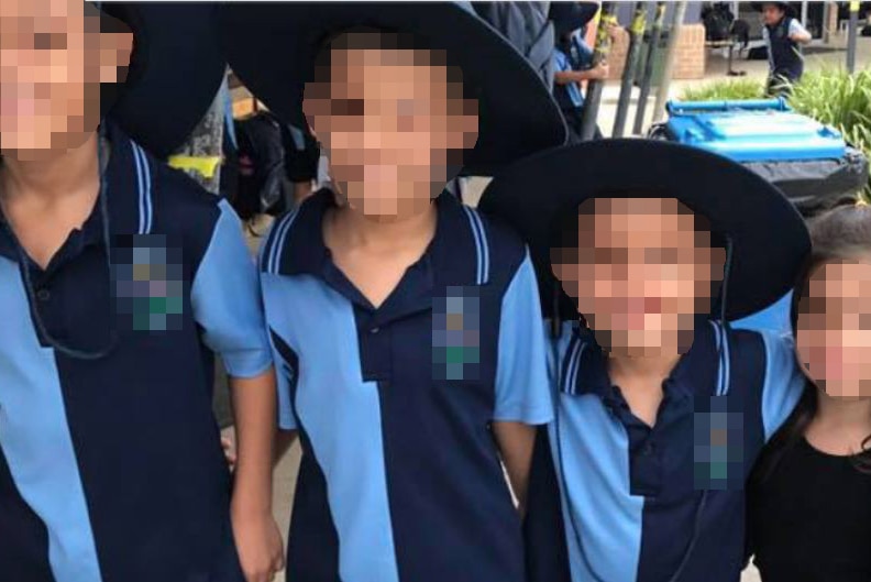 Four children with their faces pixelated.