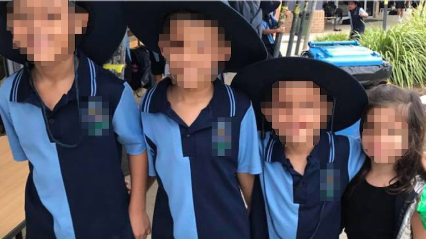 Four children with their faces pixelated.