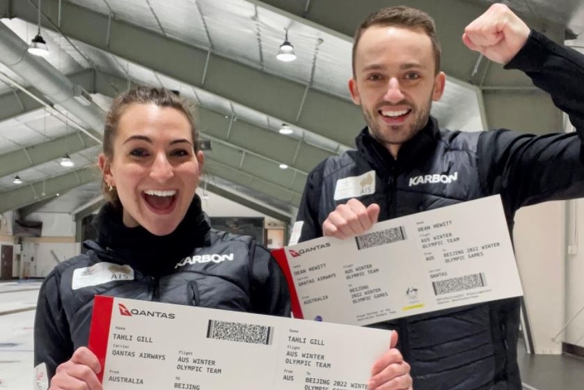 澳大利亚冰壶运动员塔莉·吉尔和迪恩·休伊特手持前往北京参加冬奥会的门票。