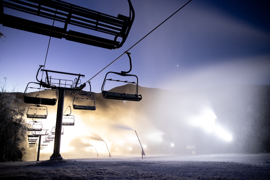 Sillouette of ski chair lifts in snowy atmosphere