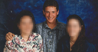 A teenage boy with his two sisters. The girls' faces are pixelated.