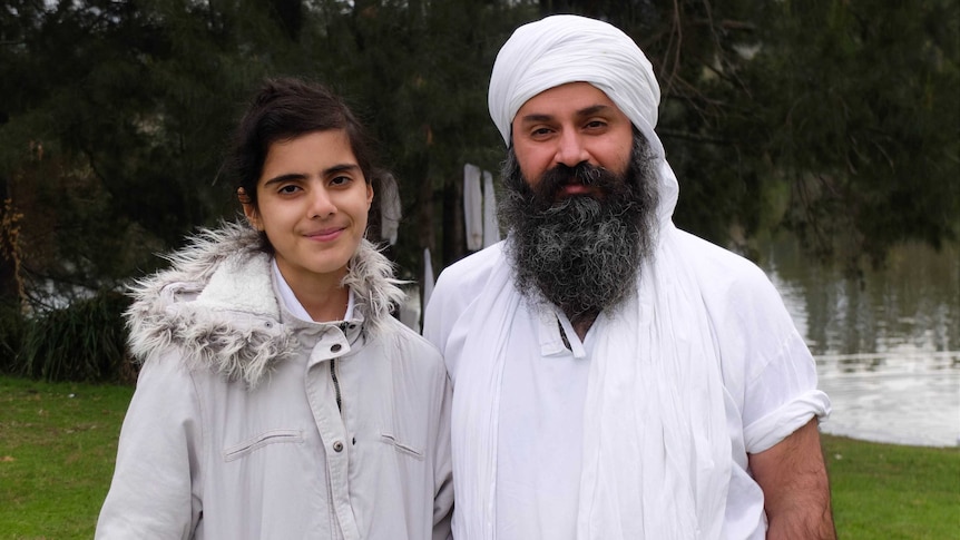 Anwar Hasan and her father, a Mandaean priest, beside the Nepean River.