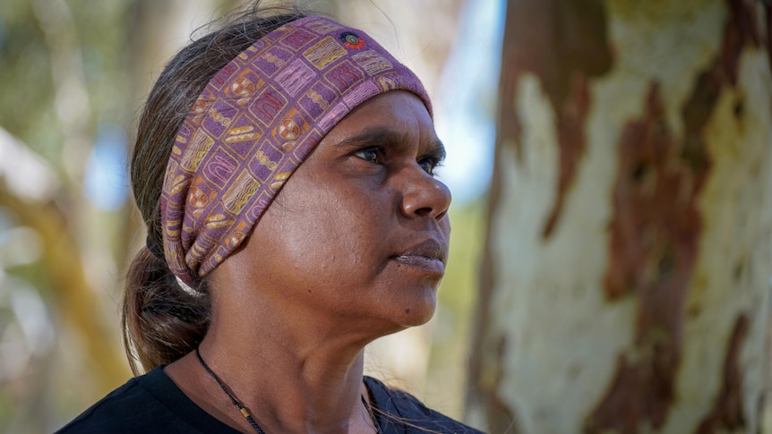 An Aboriginal woman gazes into the distance