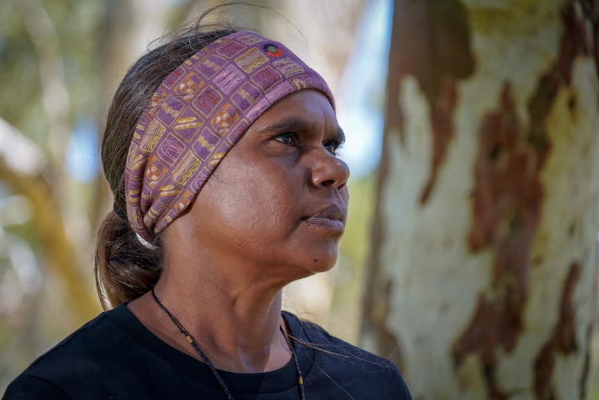 An Aboriginal woman gazes into the distance