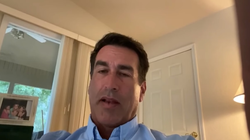 Rob Riggle records himself with a finger over the lens