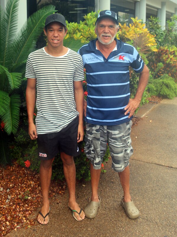 Footballer Michael Hagan (left) stands with his father, legendary NTFL player Norm Hagan