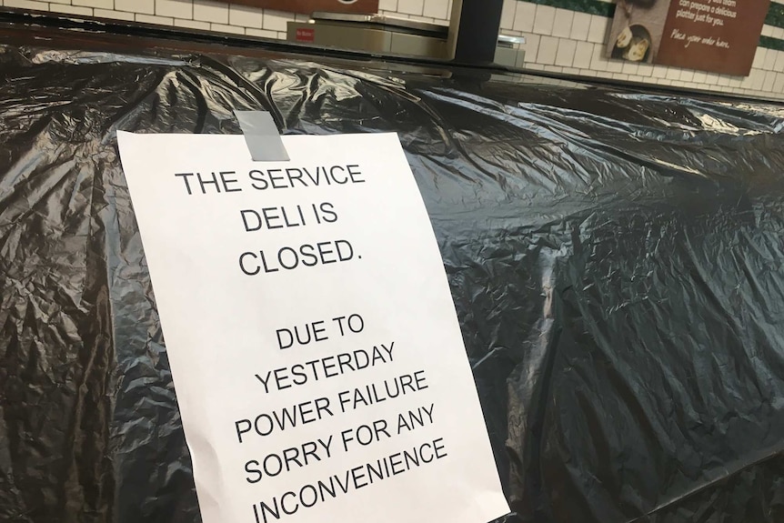 A sign reading: 'the service deli is closed, due to yesterday power failure sorry for any inconvenience' at the Woolworths deli