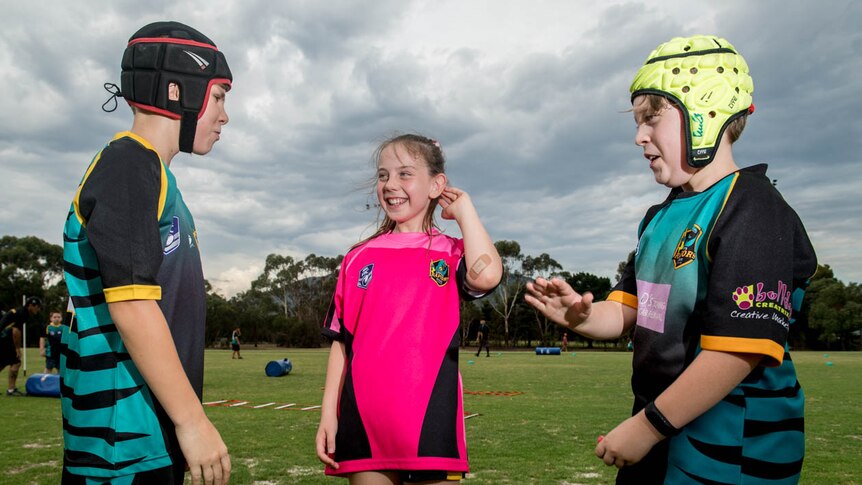 Jack Earney (left) Mia Johnson (centre) and Cooper Allan (right) are seen speaking during Eastern Raptors training.