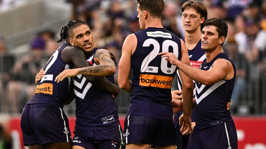 Michael Walters gets a hug from some Fremantle teammates