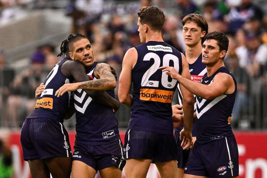 Michael Walters gets a hug from some Fremantle teammates