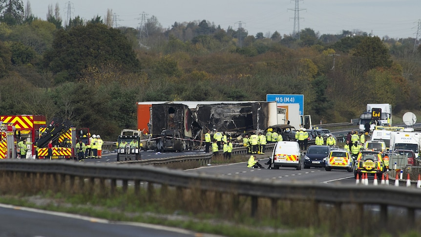 Rescue workers gather around the scene of an accident which occurred on the M5 motorway near Taunton in Somerset.