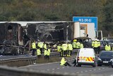 Rescue workers gather around the scene of an accident which occurred on the M5 motorway near Taunton in Somerset.