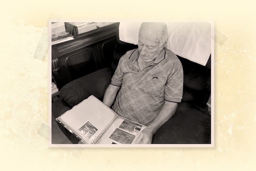 A man sits on a chair and looks through a photo album.