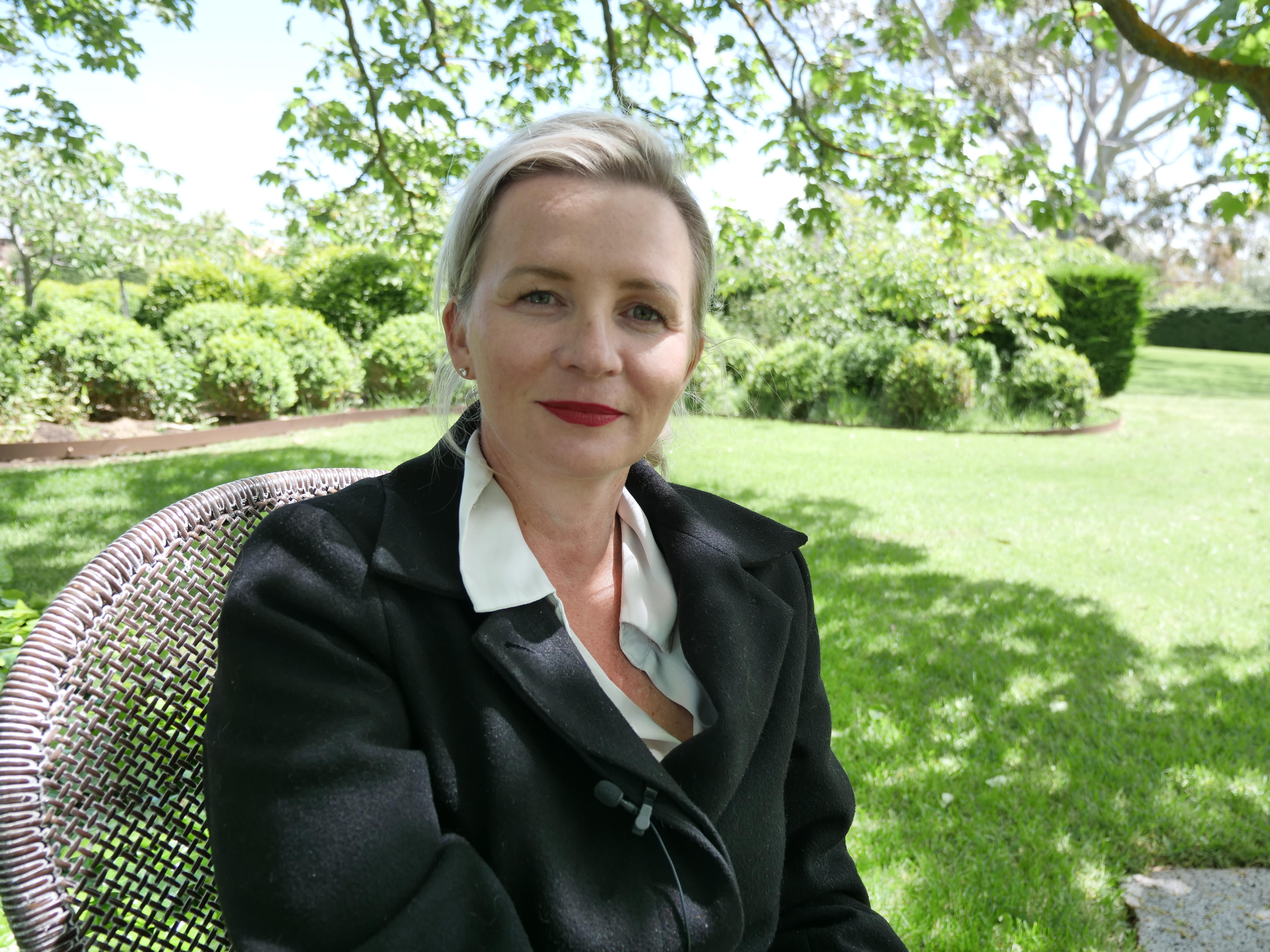 woman sitting in green garden
