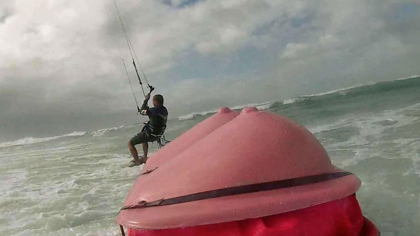 Richard Hatherall is part of a team of kite surfers who will lug a giant pair of fibreglass breasts across Torres Strait.