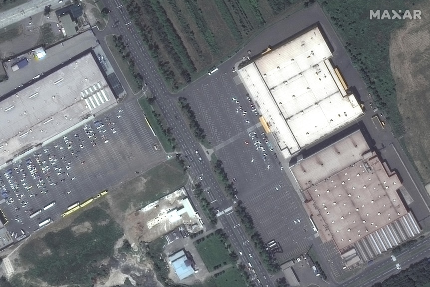 A satellite image shows a top-down look at a series of shopping centres and large car parks.