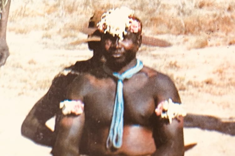 A man wearing Indigenous ceremonial decorations.