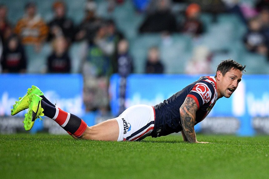 Mitchell Pearce lying on the ground after scoring a try for the Roosters