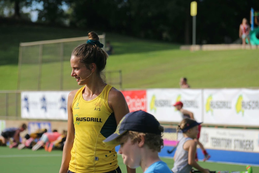 Brooke Peris talks with young hockey players