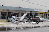 A view of vehicles damaged by the collapse of the facade of a department store