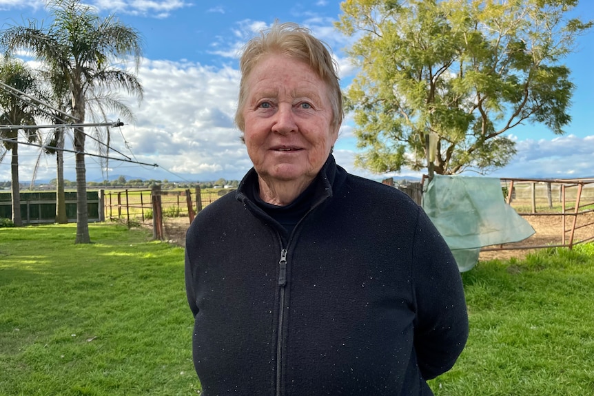 Image of a woman standing in a field.