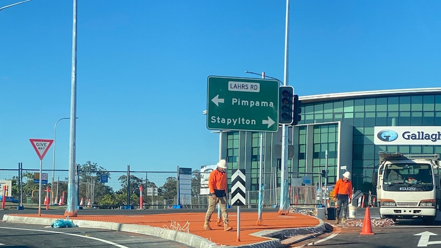 A road sign that reads "Pimpama", with an arrow pointing left; and "Stapylton", with an arrow pointing right